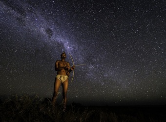 Khalahari Plains Camp, spectacular stars, local African native in traditional dress with a handmade bow and arrow, milky way, Botswana, Africa