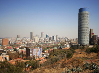 View of the city of Johannesburg from several miles away showing the skyline and a large grainery in South Africa