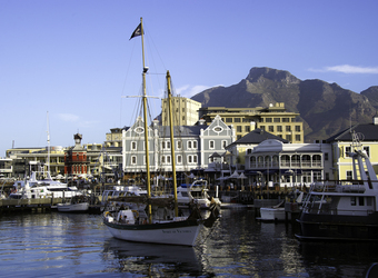 Cape Town, where the Indian and Atlantic Oceans meet, view of the ocean and sailboats and quaint beautiful houses with a huge mountain in South Africa